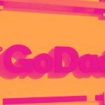 Financial analysts reviewing GoDaddy stock charts showing slowing growth metrics