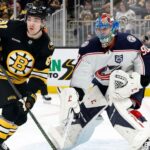 Boston Bruins players celebrating a goal during a crucial NHL game impacting the Eastern Conference wild card race