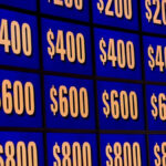 Jeopardy! host Alex Trebek and contestants on the iconic game show set celebrating 62 years