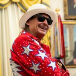 Kid Rock saluting next to an Army Apache helicopter flying near his Nashville home, sparking taxpayer funding debate
