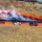 Aerial view of Oklahoma wildfires raging across dry grasslands under smoky skies