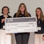 Purdue University student team holding award for SoySeal soy-based adhesive tape innovation
