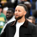 Stephen Curry sitting on the Warriors bench with a knee injury, Warriors face play-in pressure