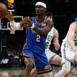Oklahoma City Thunder player driving to the basket against the Chicago Bulls defense in an NBA game