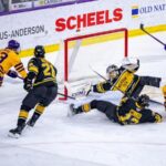 Western Michigan Broncos and Minnesota State Mavericks players face off in an intense NCAA hockey game rematch