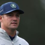 Bryson DeChambeau holding his custom 3D-printed 5-iron at the 2026 Masters tournament