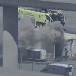 Aerial view of smoke from cargo pallet fire at San Francisco International Airport freight area
