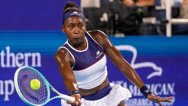 Coco Gauff smiling confidently with her natural 4C hair in the Miu Miu advertisement