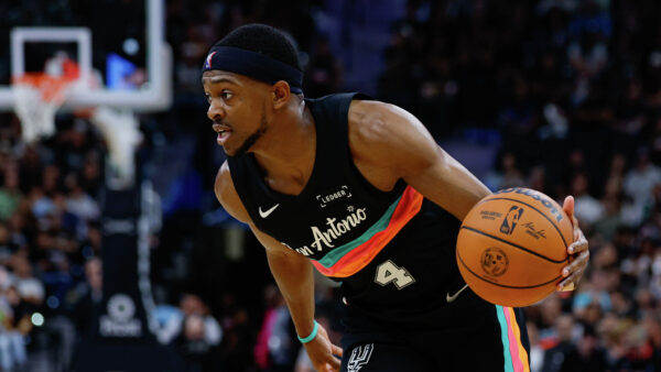 De'Aaron Fox in a San Antonio Spurs uniform during a game, focused on winning a championship