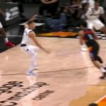 Devin Booker scoring an and-one basket for the Phoenix Suns in an NBA game