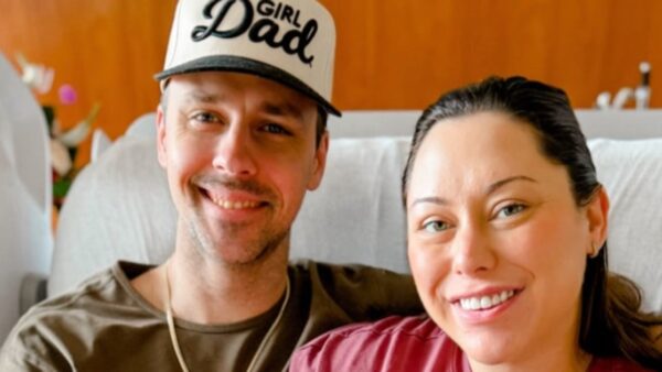 Alaina Scott and Matt Moeller hold their newborn baby girl Scottie Marie's hand