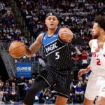 ESPN analyst discussing NBA playoffs betting tips and fantasy basketball picks on screen