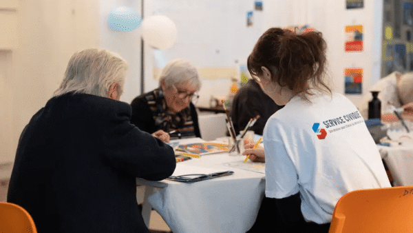 Young civic service volunteer visiting an elderly person at home in Villefranche-de-Rouergue, France