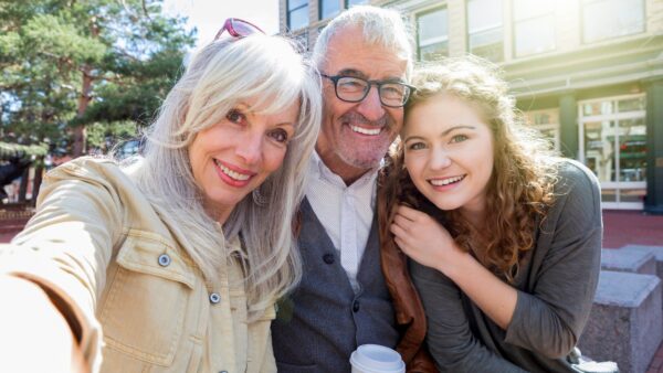 Retired grandparents discussing college funding and financial pressure with family