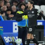 Pep Guardiola looks concerned during a press conference discussing Bernardo Silva's Manchester City future