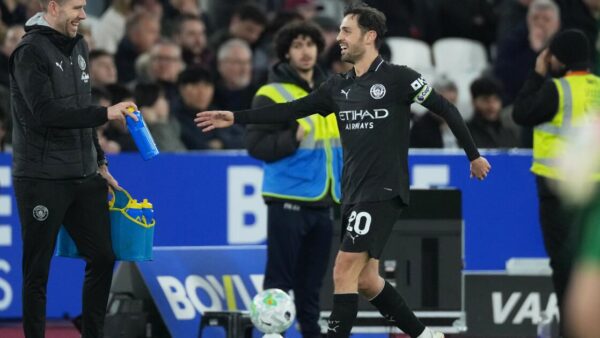 Pep Guardiola looks concerned during a press conference discussing Bernardo Silva's Manchester City future