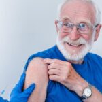 Senior receiving a high-dose flu shot for Alzheimer's risk reduction
