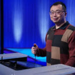 Jamie Ding celebrates his 20th consecutive Jeopardy win on stage