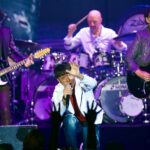 Journey band members performing on stage during their farewell tour