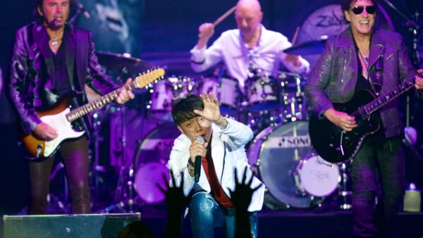 Journey band members performing on stage during their farewell tour