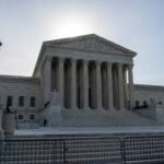 Justice Clarence Thomas speaking at the Supreme Court after breaking his decade-long silence during oral arguments