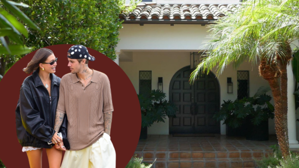 Justin and Hailey Bieber posing in front of one of their luxury real estate properties