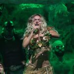 Karol G performing on stage at Coachella music festival