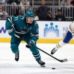 Macklin Celebrini celebrates after scoring for the San Jose Sharks, joining the elite NHL teen 100-point club