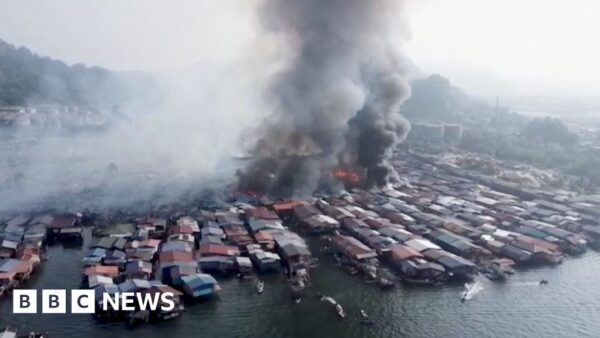 Aerial view of massive fire destroying wooden stilt houses in a Malaysian water village in Sabah