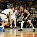 Mavericks vs Suns players in action during the final late-night NBA game of the season