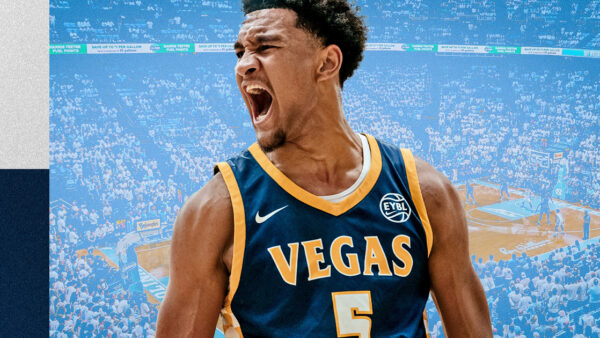 Maximo Adams in UNC jersey confirming commitment to Tar Heels under coach Michael Malone