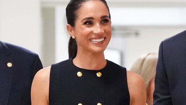 Meghan Markle wearing a black dress and earrings from her Australia tour, featured on the OneOff AI fashion platform