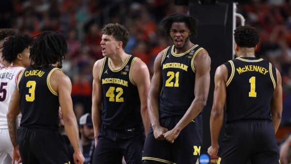 Michigan Wolverines player celebrating historic Final Four victory over Arizona Wildcats