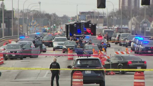 Milwaukee police officers at the scene of a shooting after a pursuit linked to a homicide