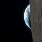 NASA astronaut Reid Wiseman films Earth setting behind the moon from the Orion spacecraft window during Artemis II mission