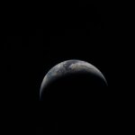 NASA Artemis II Earth image showing a crescent Earth from the Orion spacecraft window for Earth Day