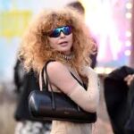 Natasha Lyonne wearing a sheer bodysuit and lace-up shorts at a public event