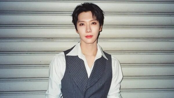 NCT member Ten smiling at a press conference