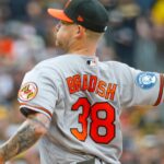Baltimore Orioles pitcher Kyle Bradish warming up before a game seeking redemption against the White Sox