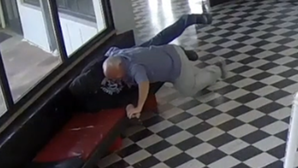 Security video still showing Pauls Valley Principal Kirk Moore tackling a gunman in the school lobby