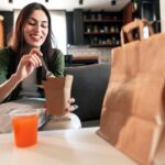 Restaurant customers enjoying Tax Day food deals and discounts at a table