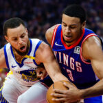 Sacramento Kings players huddle during a timeout in a crucial late-season NBA game