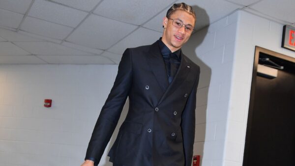 San Antonio Spurs team members arriving in matching black suits for their playoff game against the Portland Trail Blazers