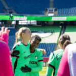 San Diego Wave FC players celebrating a goal against Boston Legacy in NWSL action at Snapdragon Stadium