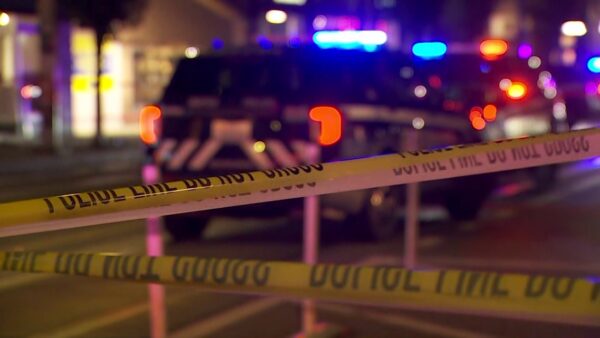 Seattle police investigate a drive-by shooting scene in the Rainier Beach neighborhood