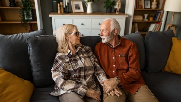 Senior couple discussing roof replacement financing options with a financial advisor