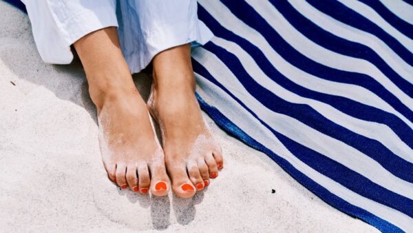 Summer 2026 pedicure colors trend featuring dessert and sky inspired nail polish shades like creamy white, pistachio green, and sky blue