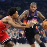 Phoenix Suns and Chicago Bulls players battling in a crucial NBA game for playoff positioning