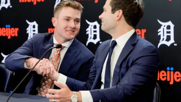 Detroit Tigers president Scott Harris shakes hands with infielder Kevin McGonigle after signing $150 million contract extension