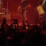 Tom Morello performing on stage, blending guitar music with political activism